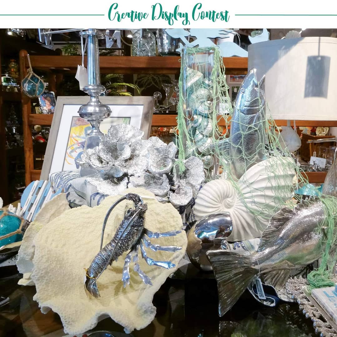 This coastal-themed display from Creative Display Contest finalist Mind’s Eye Interiors is right on trend. Click the link in bio to see other display finalists and cast your vote. • “Aloha. I have a large furniture showroom in Lahaina on the island of Maui. Along with a great selection of furniture, we feature a lot of accessories, lamps, rugs, and wall décor. We love doing creative tabletop displays in the showroom to feature new accessories when they come in. The coastal theme is our favorite because it’s so apropos for our location.” — Jean Millsap