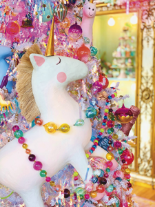 Glitterville Studio Store merchandise display featuring unicorn