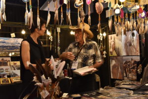 A vendor and buyer chat at the Las Vegas Souvenir Show