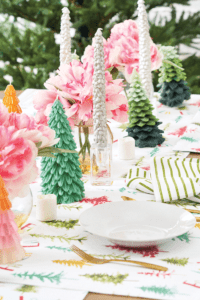 Accent items such as glittered trees, taper candles and colorful linens elevate a holiday tablescape. Photo courtesy of C&F Enterprises.